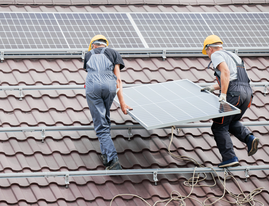 Two HPS solar experts installing a solar & backup power system on a roof of a residential home.
