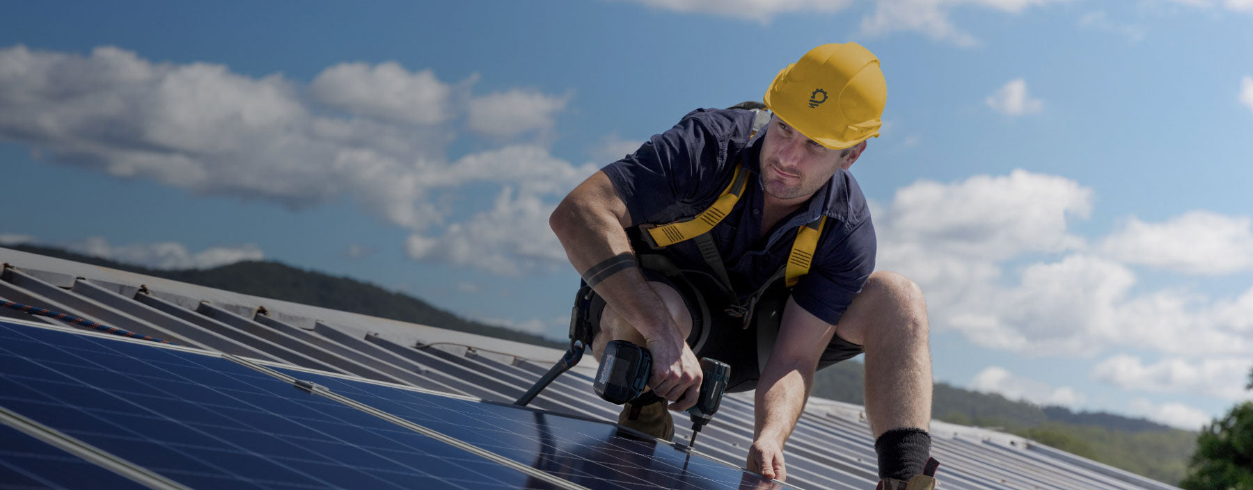 A HPS solar expert installing a solar & backup power system on a roof of a commercial building.