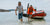 A Batt Pack Pro unit is being transported from a boat by two men.