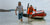 A Batt Pack Pro unit is being transported from a boat by two men.